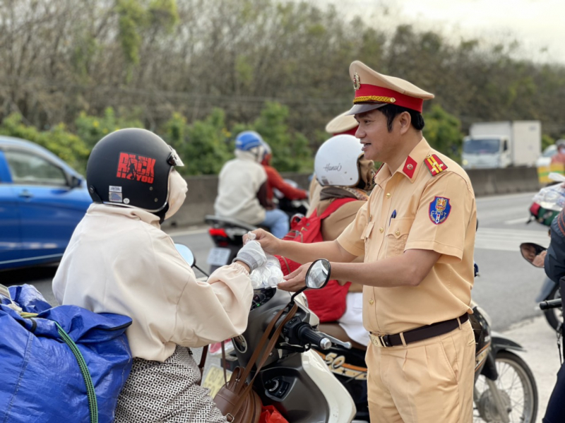 Ngoài tặng nước uống, CSGT còn thăm hỏi, chúc sức khỏe người dân.