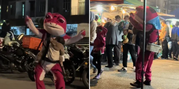 hình ảnh một người đàn ông mặc bộ đồ ếch hồng nhảy múa mưu sinh, trên ngực vẫn ôm trọn con nhỏ, đã khiến hàng triệu người rưng rưng.